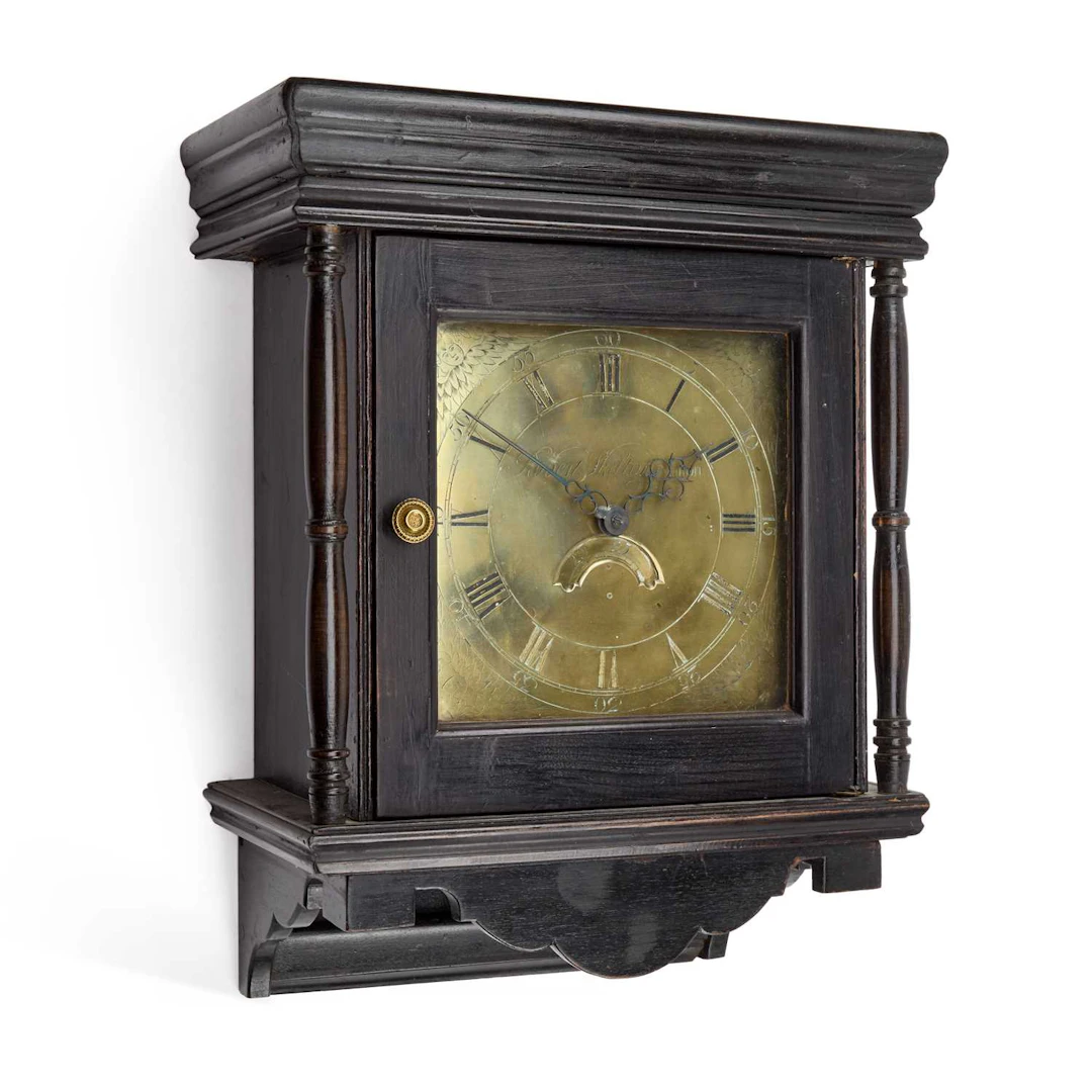 AN EBONISED THIRTY-HOUR WALL CLOCK / AN OAK THIRTY-HOUR WALL CLOCK