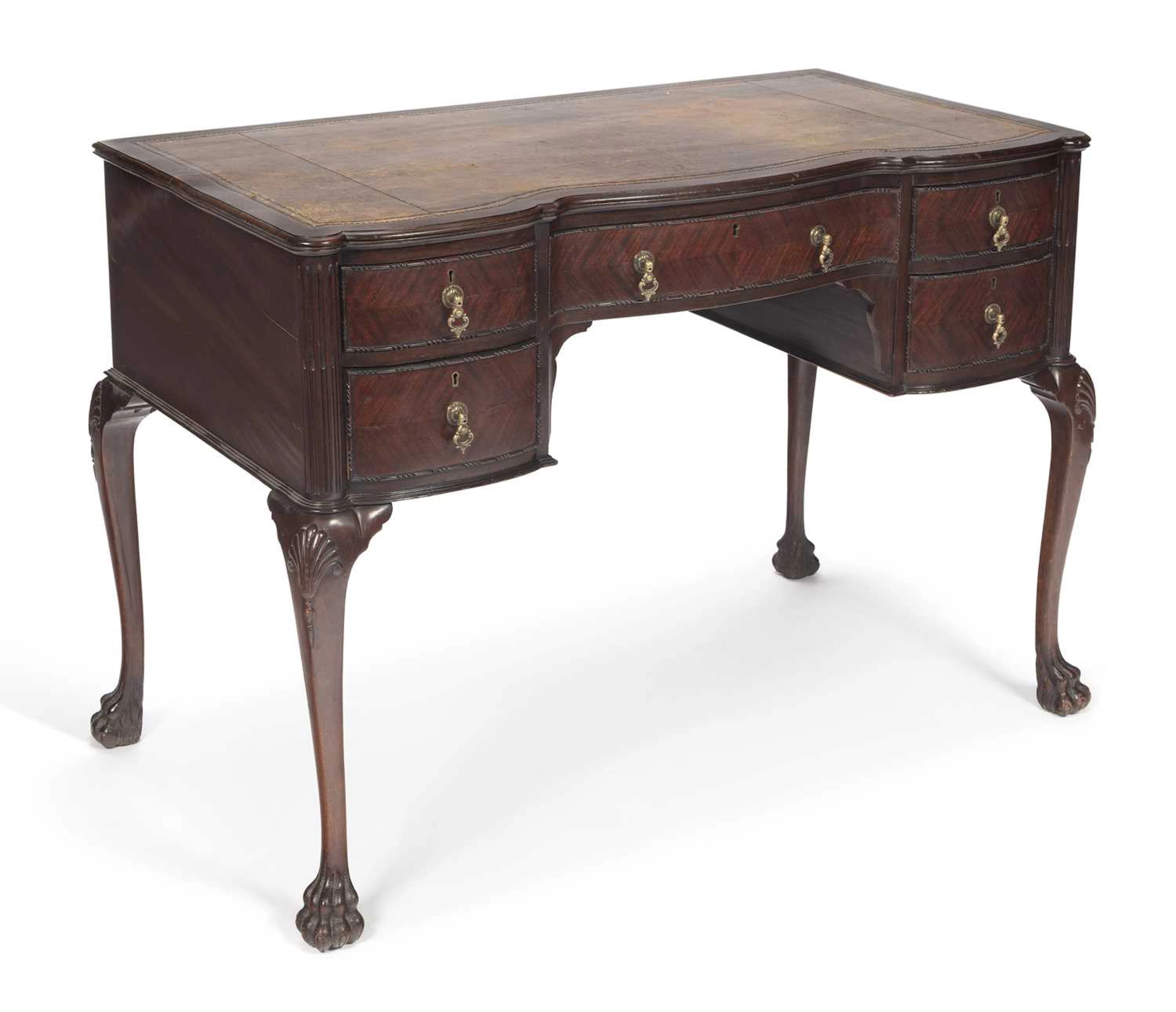 A MAHOGANY SERPENTINE WRITING TABLE STAMPED EDWARDS & ROBERTS