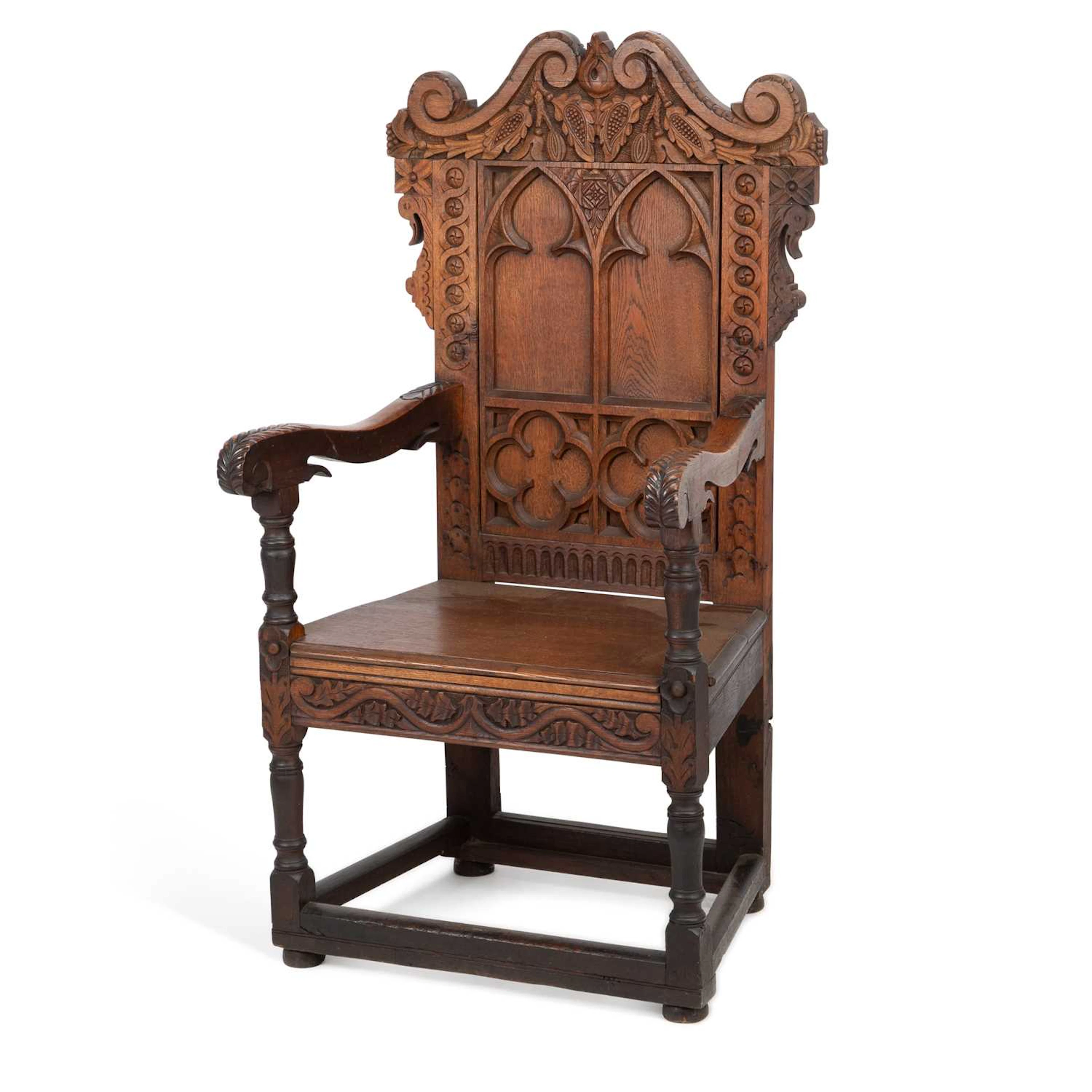 A CARVED OAK ARMCHAIR