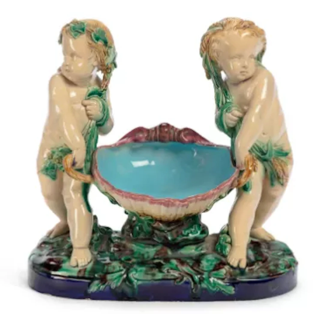 A MINTON MAJOLICA CHERUBS BASKET DATED 1868