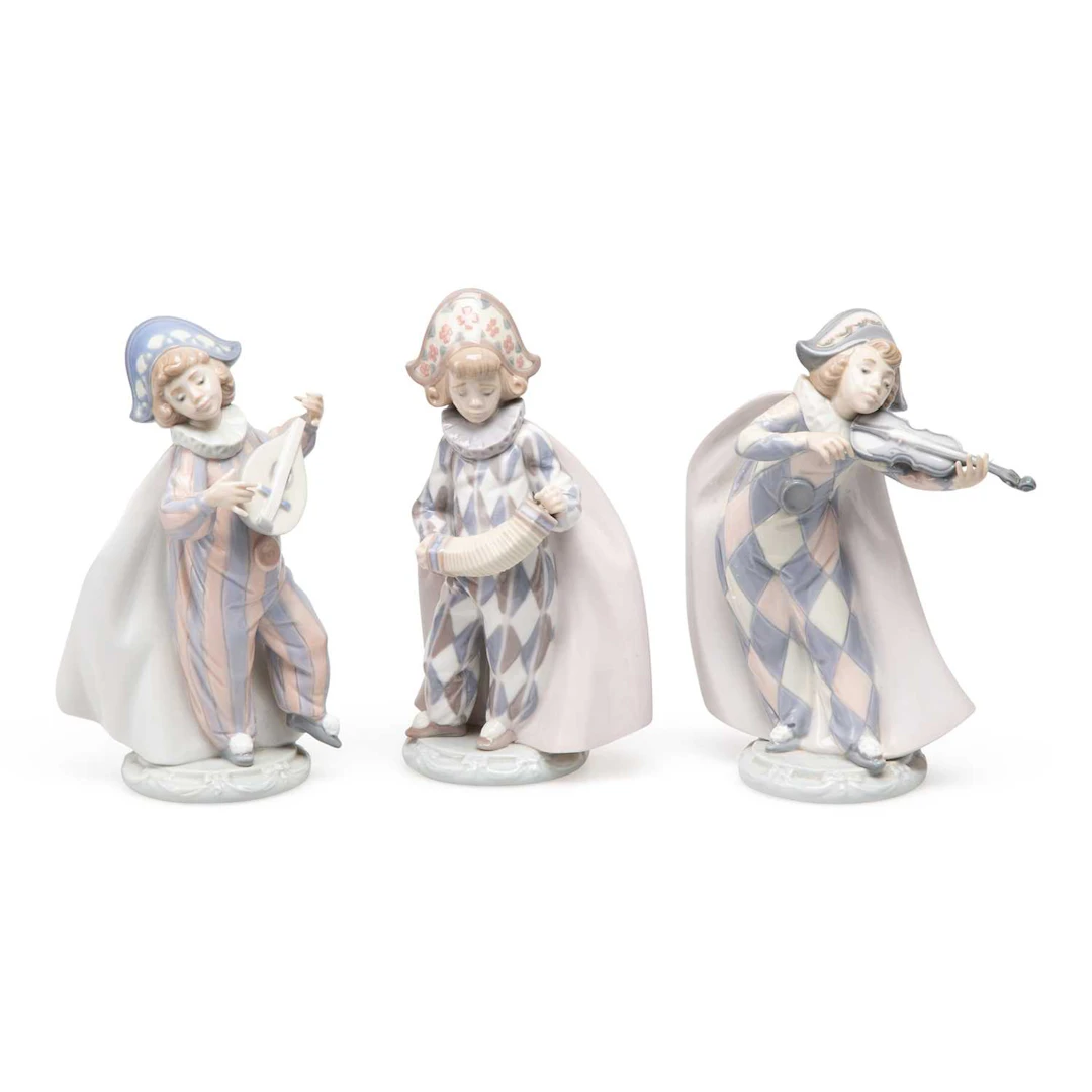THREE LLADRÓ FIGURES OF HARLEQUIN MUSICIANS