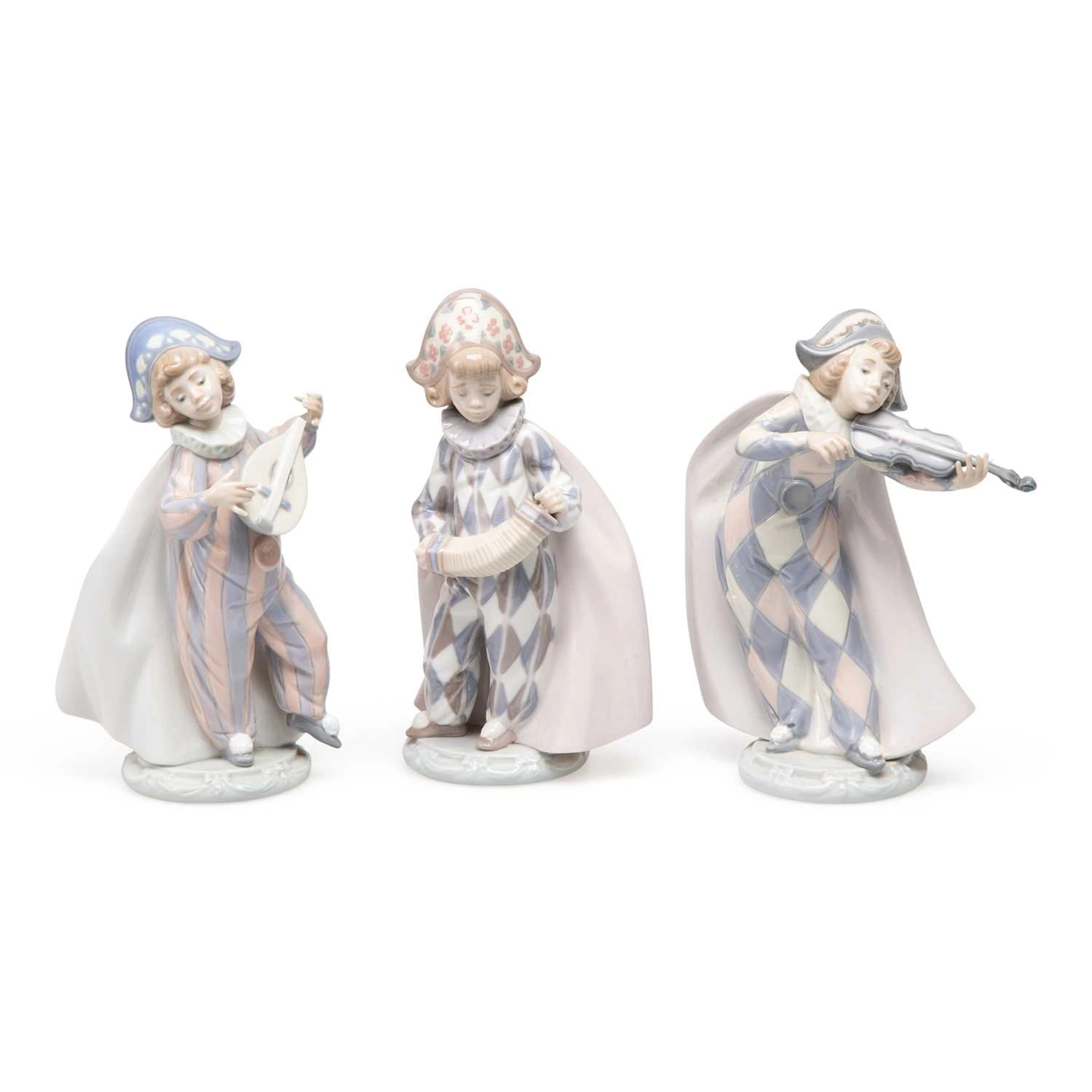 THREE LLADRÓ FIGURES OF HARLEQUIN MUSICIANS