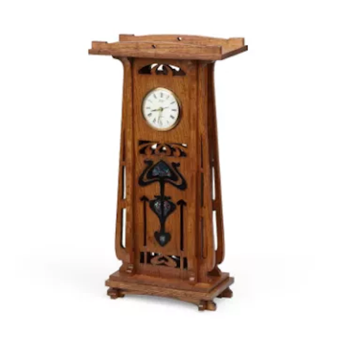 AN OAK MANTEL CLOCK IN THE ART NOUVEAU TASTE