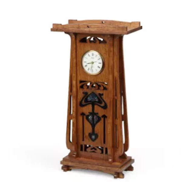 AN OAK MANTEL CLOCK IN THE ART NOUVEAU TASTE