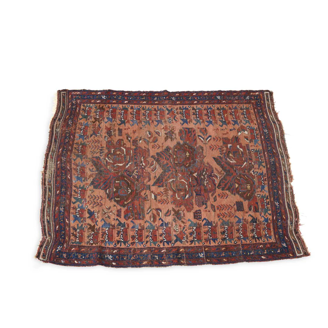 AN ANTIQUE WEST PERSIAN RUG