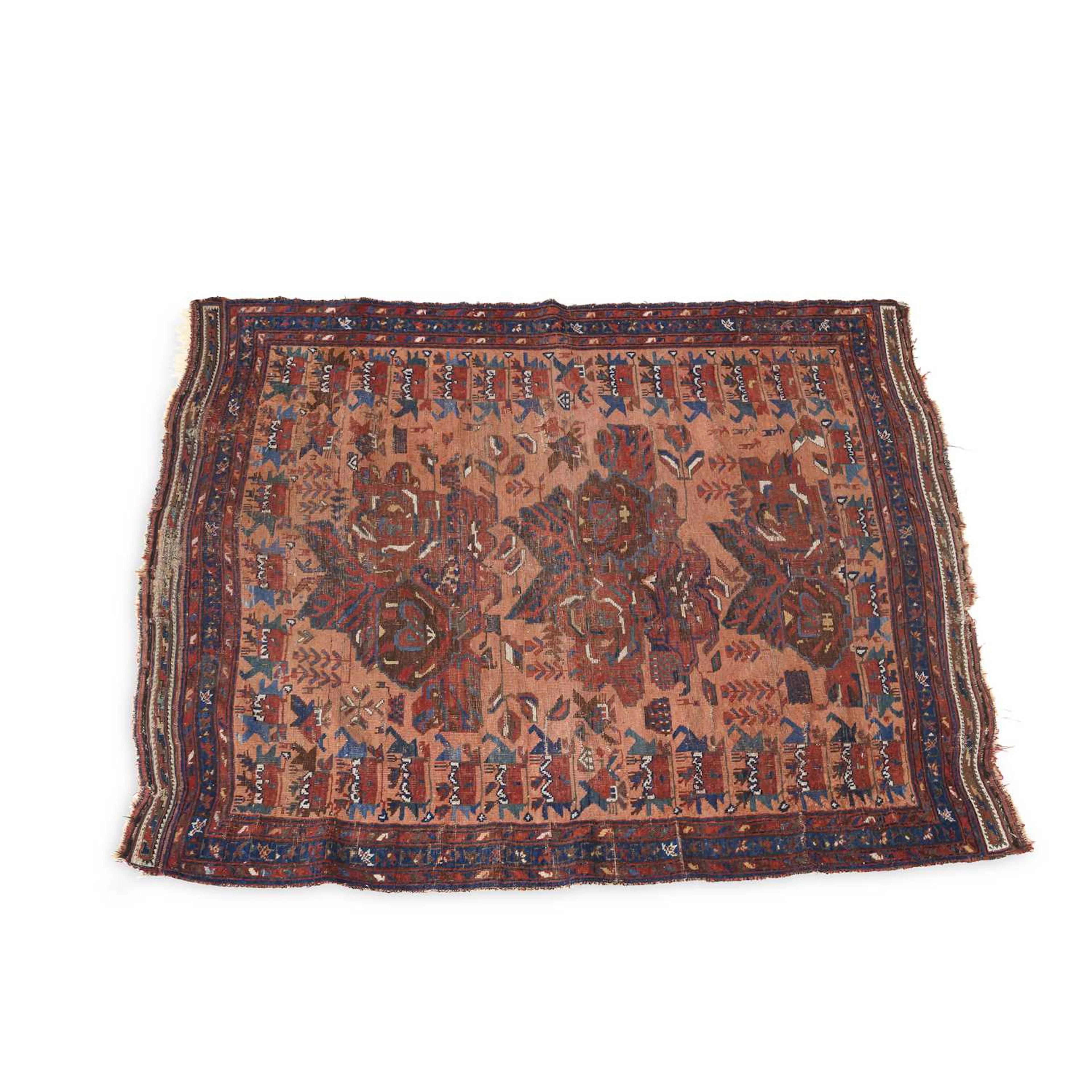 AN ANTIQUE WEST PERSIAN RUG