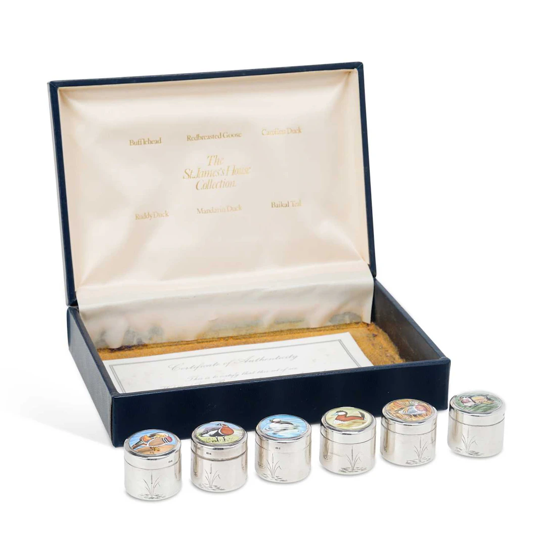AN ELIZABETH II SET OF SIX SILVER AND ENAMEL LIMITED EDITION PILL BOXES