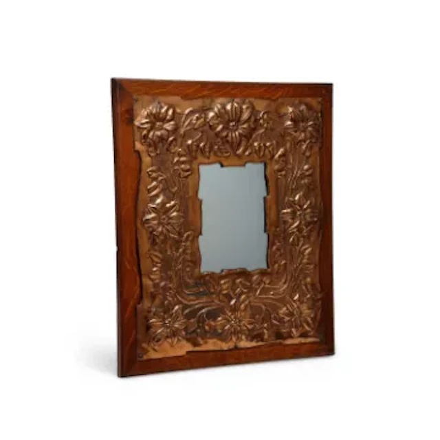 AN ARTS AND CRAFTS COPPER AND OAK WALL MIRROR