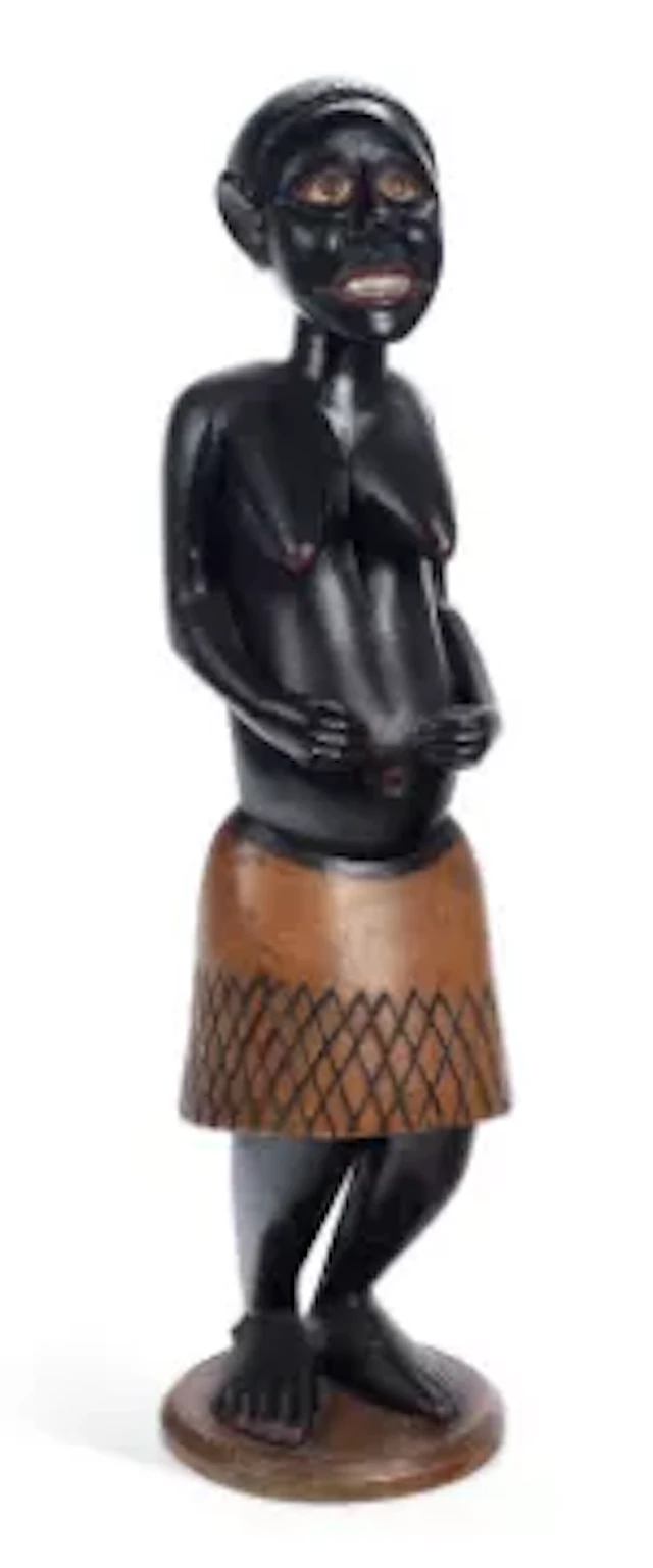 AN AFRICAN CARVED AND PAINTED WOOD FIGURE OF A WOMAN