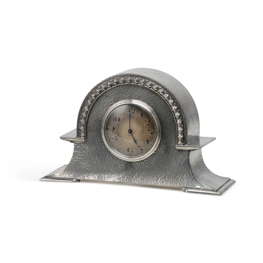 AN ARTS AND CRAFTS PEWTER MANTEL CLOCK