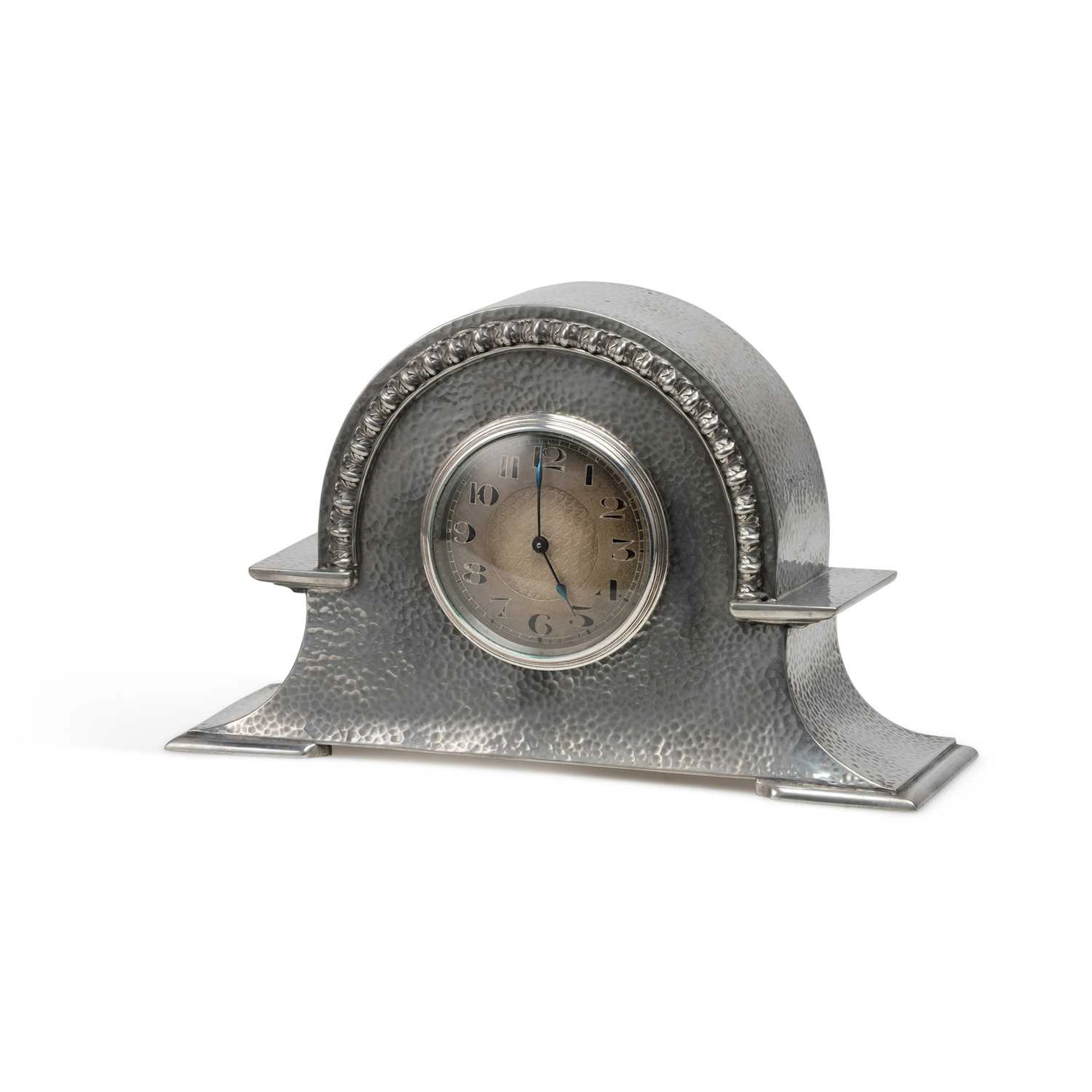 AN ARTS AND CRAFTS PEWTER MANTEL CLOCK