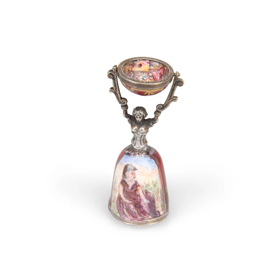 AN AUSTRIAN SILVER AND ENAMEL MINIATURE WAGER CUP MODELLED AS A MAIDEN
