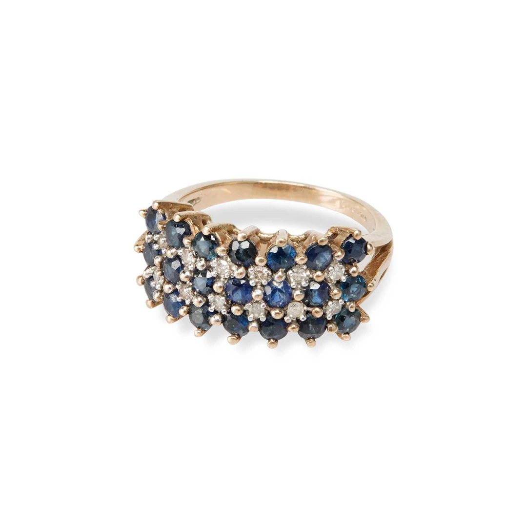 A 9 CARAT GOLD SAPPHIRE AND DIAMOND HALF HOOP RING