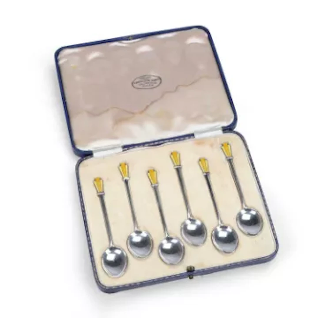 A CASED SET OF SIX ART DECO SILVER AND ENAMEL COFFEE SPOONS