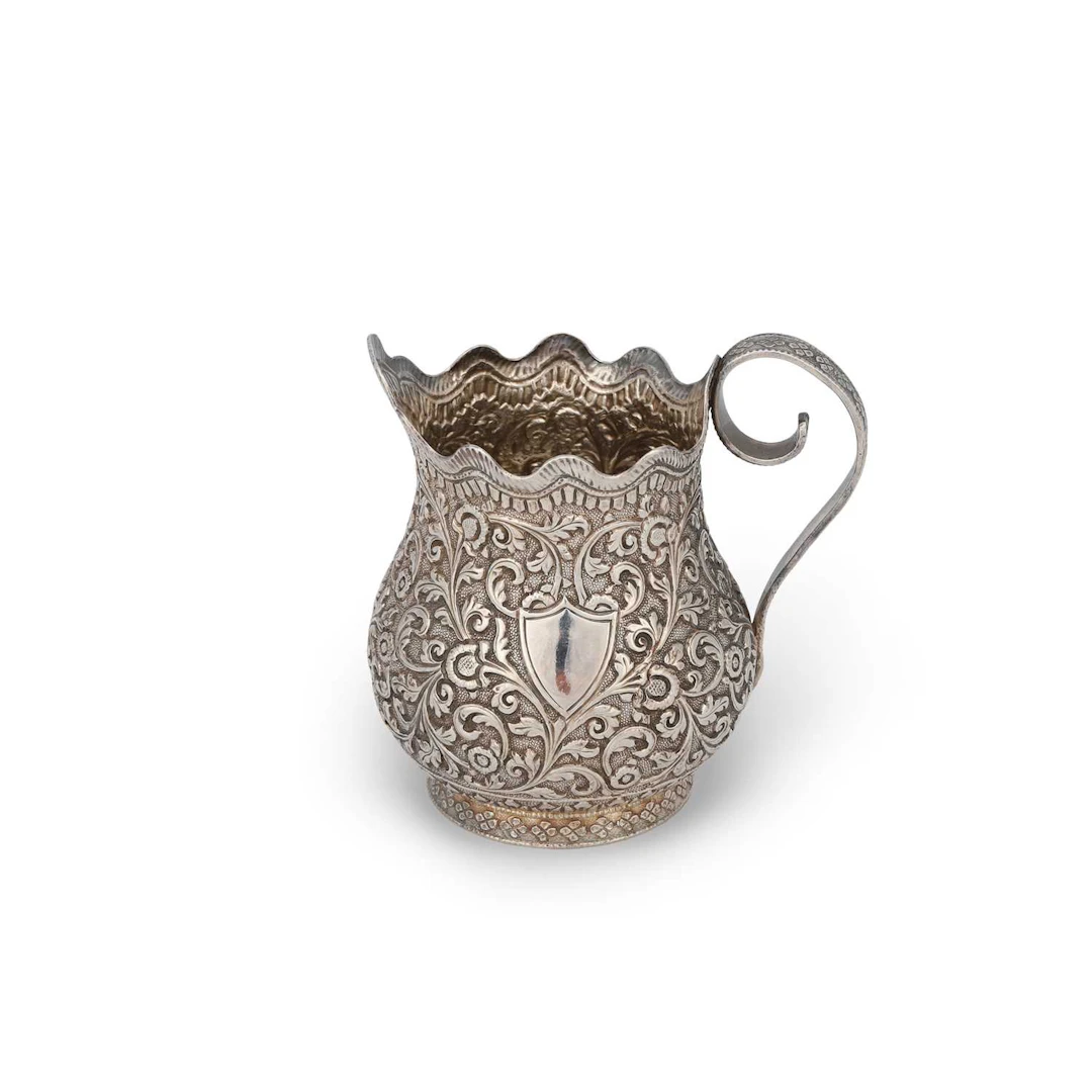AN INDIAN SILVER CREAM JUG