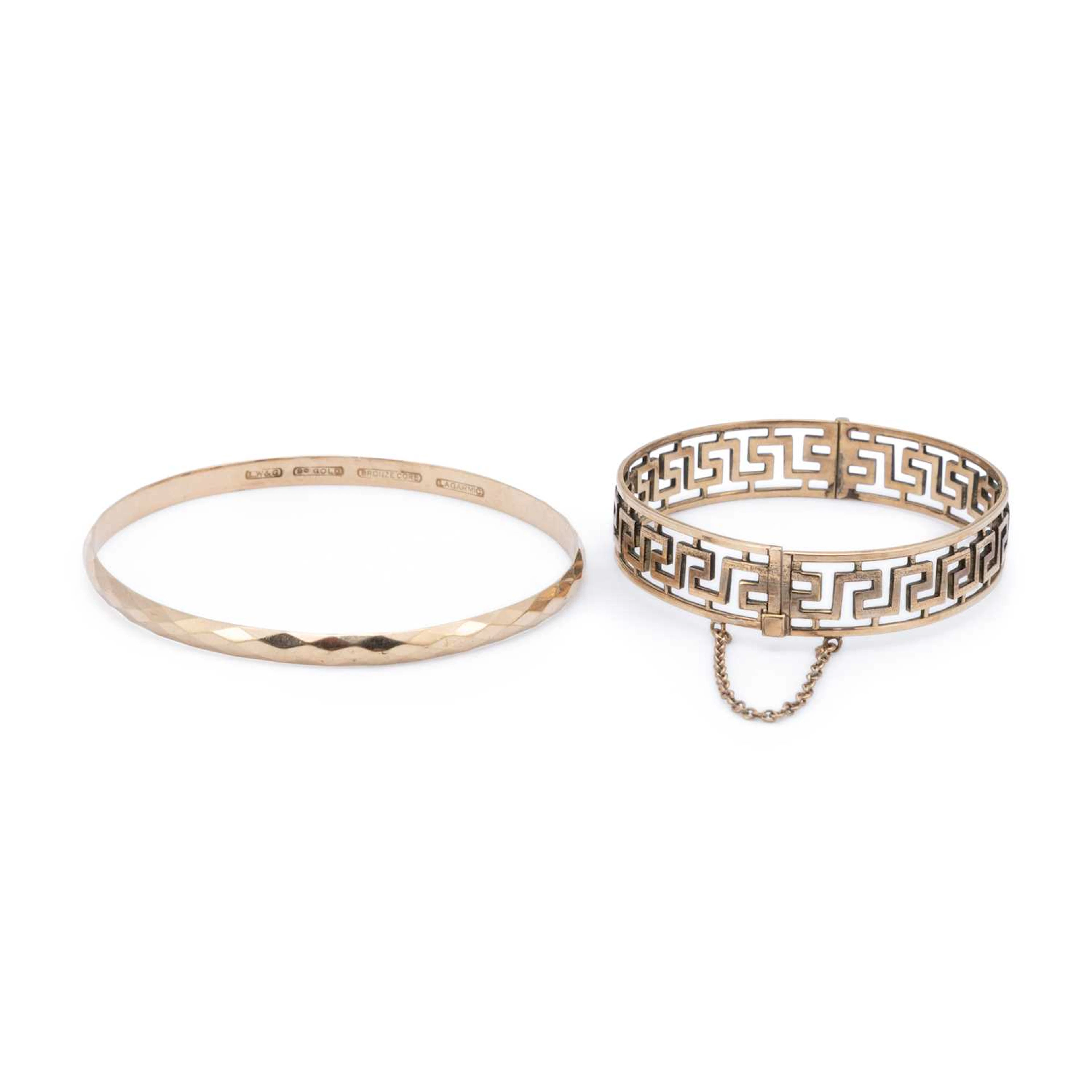 THREE ROLLED GOLD AND BRONZE CORE BANGLES