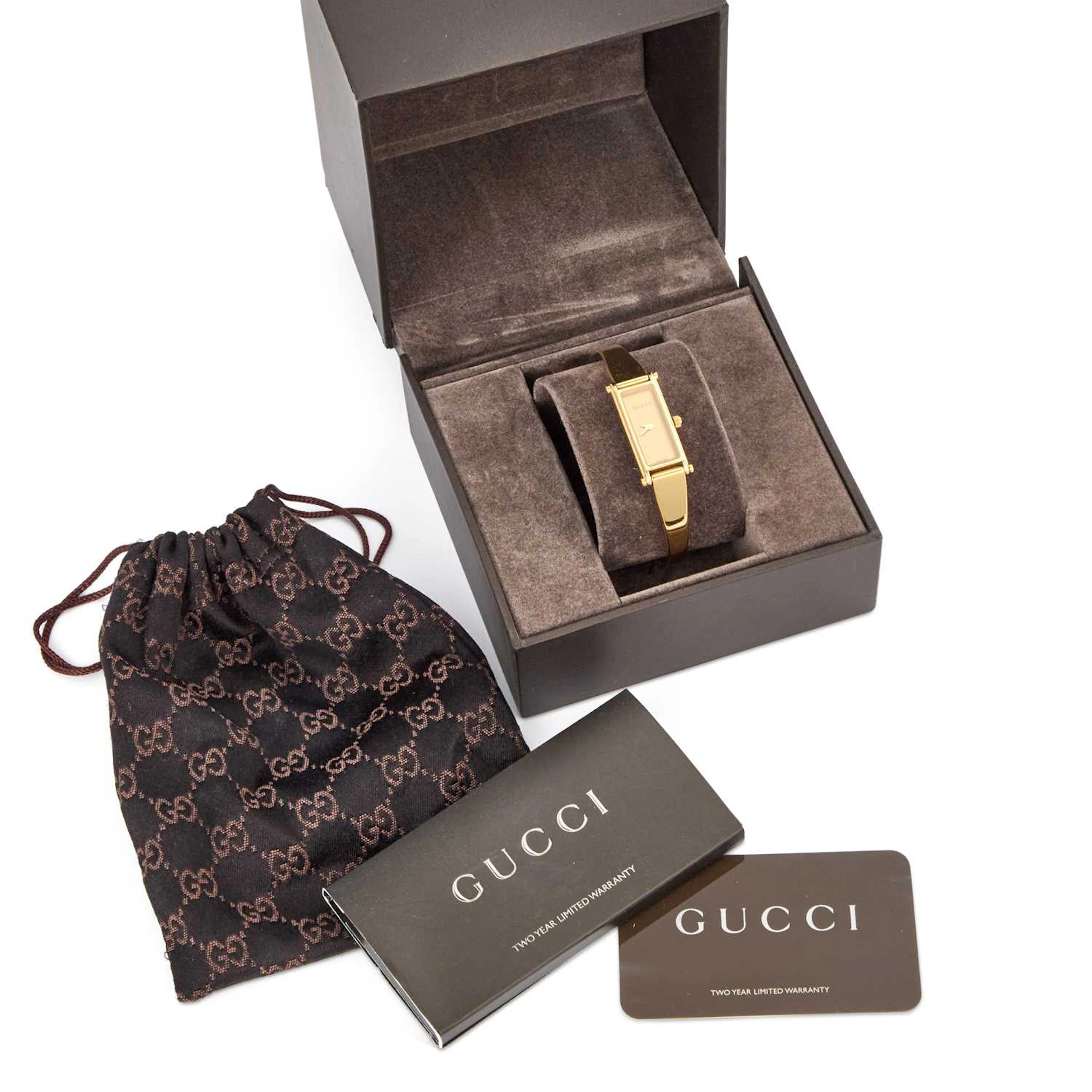 A LADY'S GOLD PLATED GUCCI BANGLE WATCH