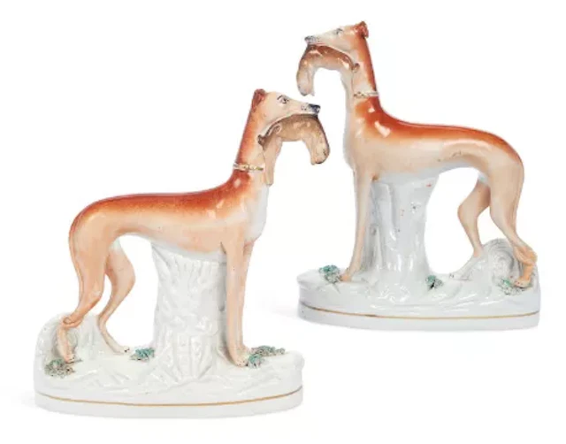 A PAIR OF STAFFORDSHIRE FIGURES OF GREYHOUNDS 19TH CENTURY