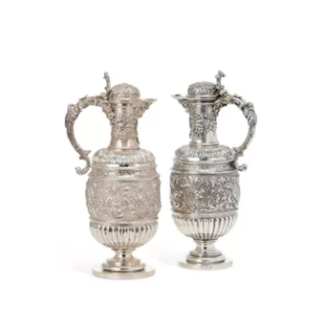 A NEAR PAIR OF VICTORIAN SCOTTISH SILVER WINE/ CLARET JUGS