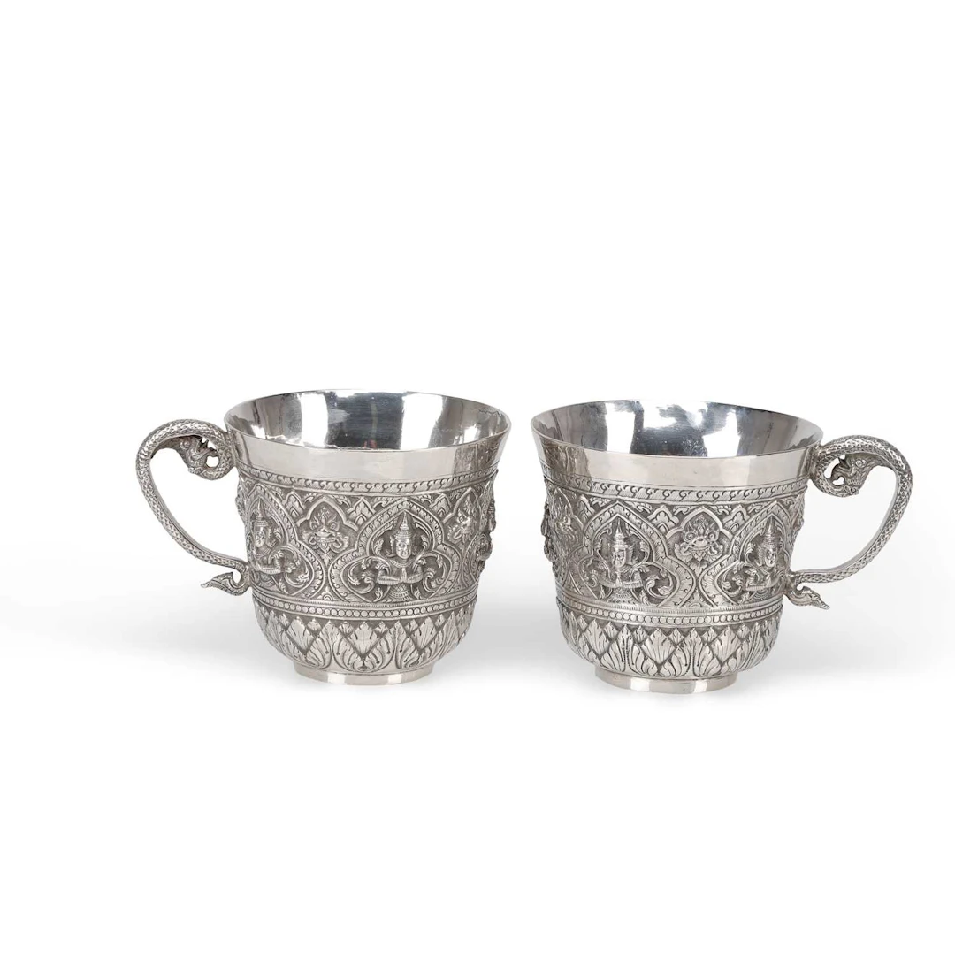 A PAIR OF SOUTH EAST ASIAN SILVER MUGS