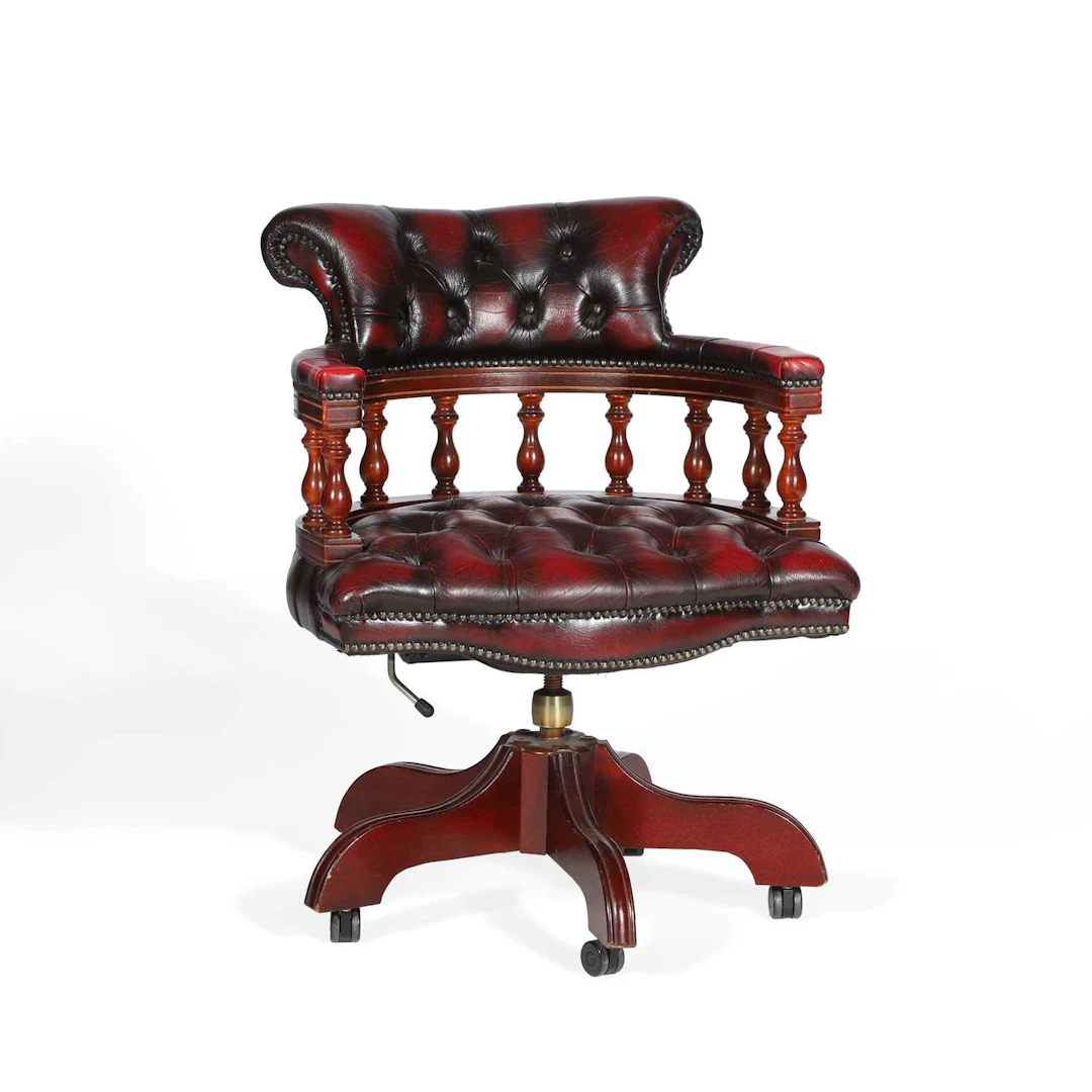 A RED LEATHER CAPTAIN'S DESK CHAIR