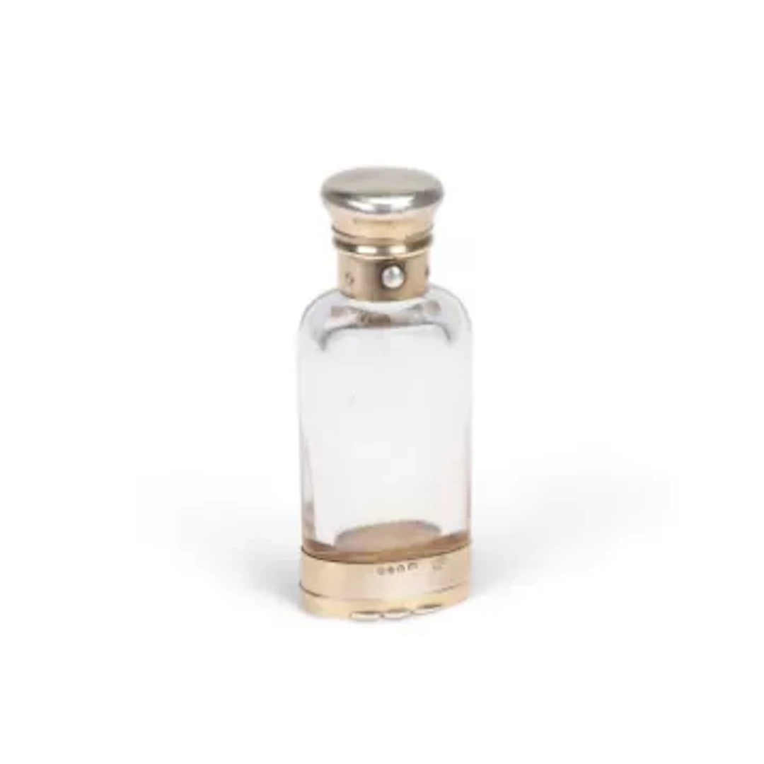 A VICTORIAN SILVER-GILT MOUNTED GLASS COMBINATION SCENT BOTTLE AND VINAIGRETTE