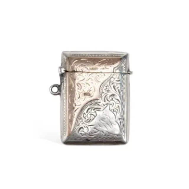 AN EDWARDIAN SILVER AND GOLD VESTA CASE