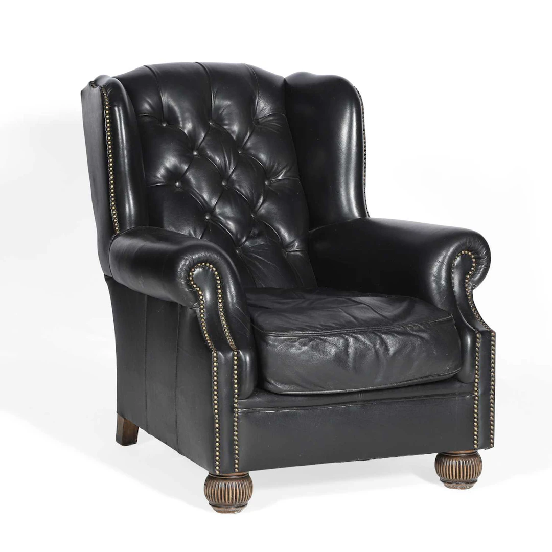 A TETRAD BLACK LEATHER WING ARMCHAIR