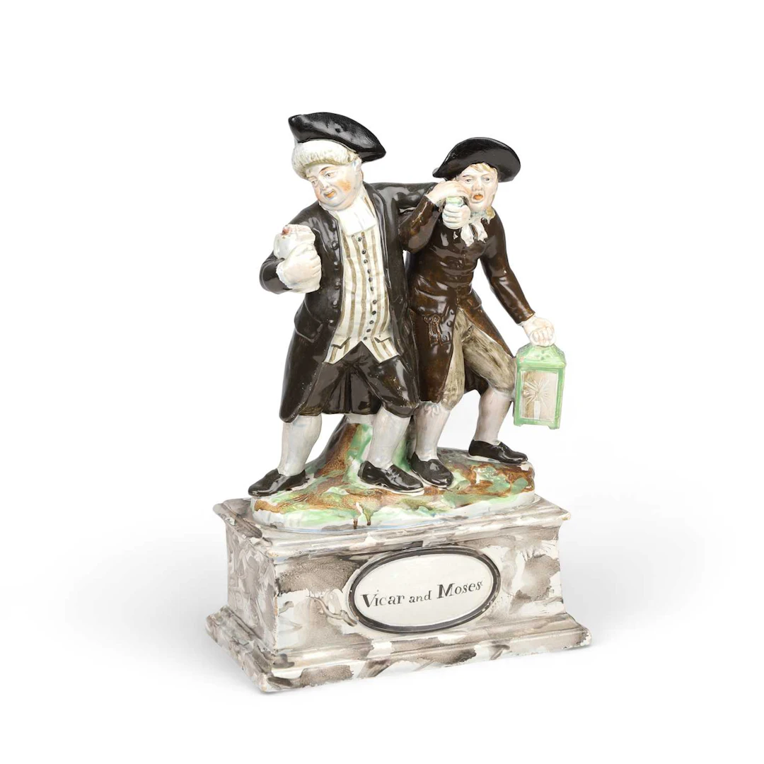 A STAFFORDSHIRE PEARLWARE GROUP OF THE VICAR AND MOSES PROBABLY ENOCH WOOD
