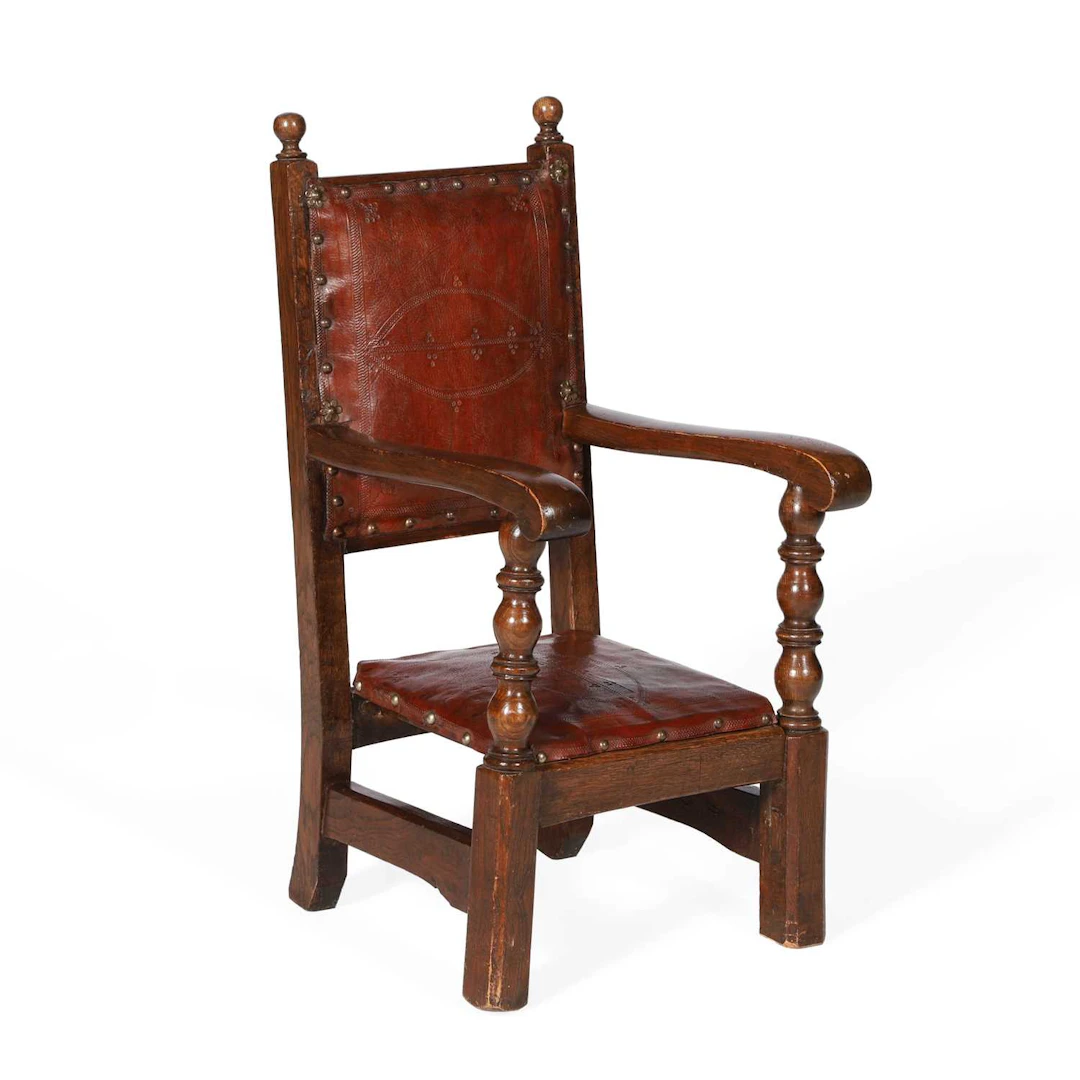 A CHILD'S OAK AND LEATHER ARMCHAIR