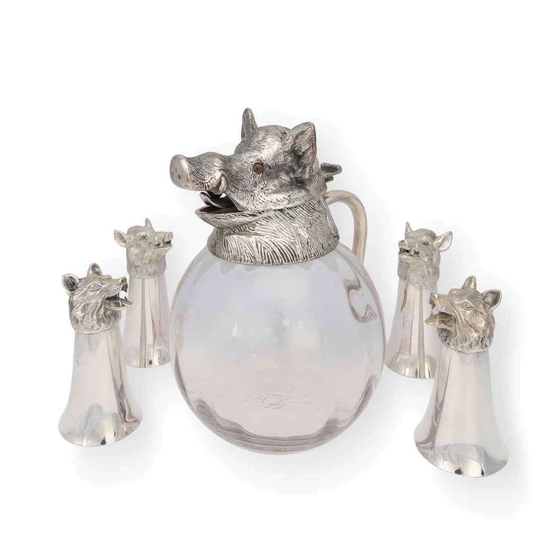 A SILVER-PLATED 'BOAR'S HEAD' CLARET JUG AND FOUR STIRRUP CUPS