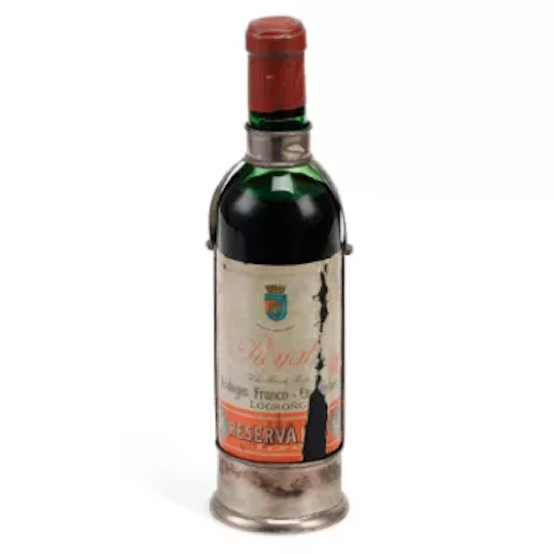 A SPANISH SILVER WINE BOTTLE HOLDER AND WINE BOTTLE