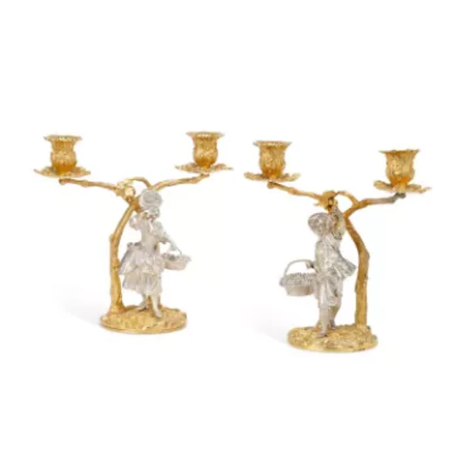 A PAIR OF ELIZABETH II SILVER AND SILVER-GILT TWO-BRANCH FIGURAL CANDELABRA