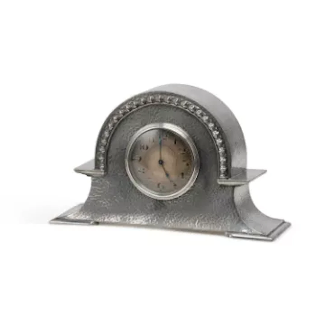 AN ARTS AND CRAFTS PEWTER MANTEL CLOCK