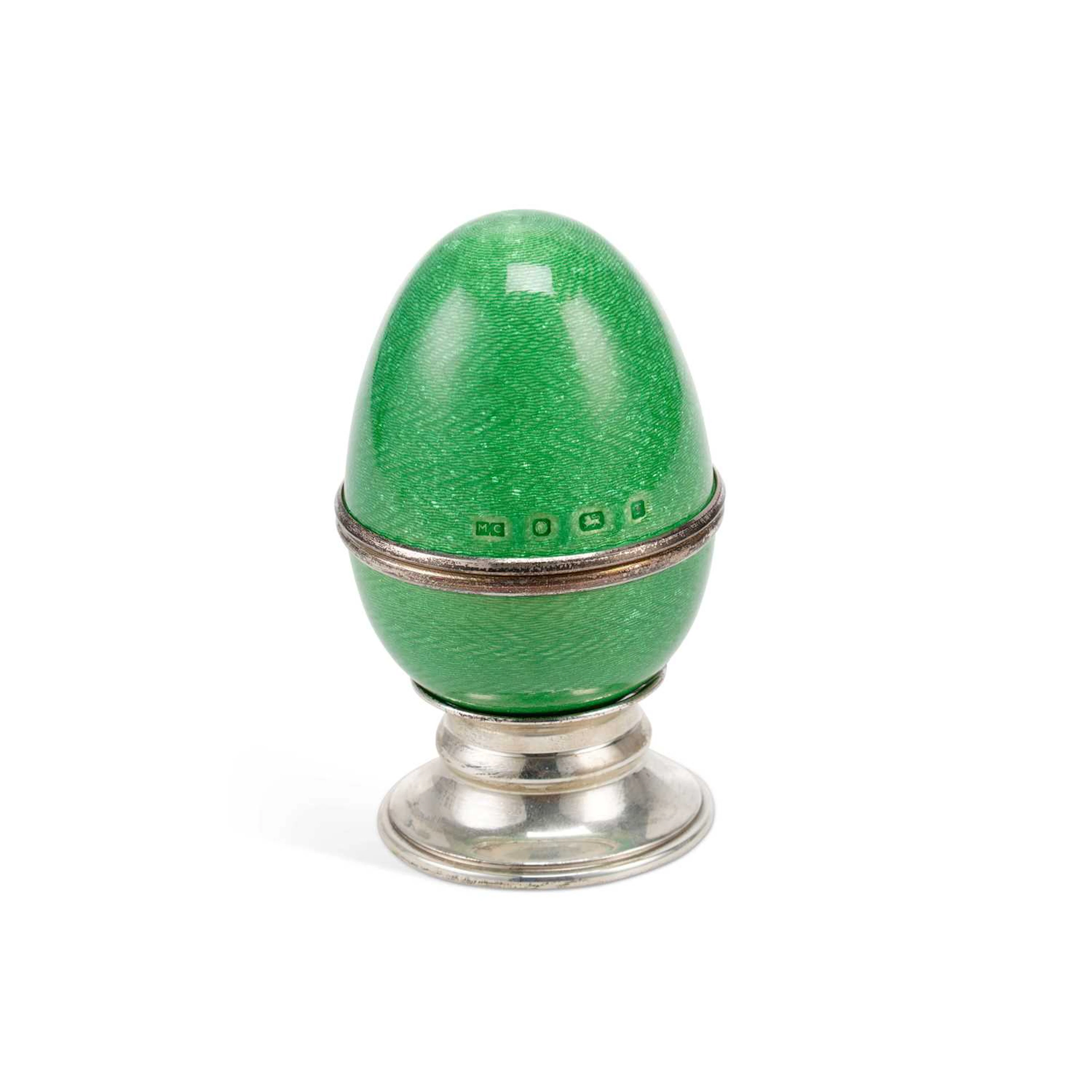 AN ELIZABETH II SILVER AND ENAMEL EGG ON STAND