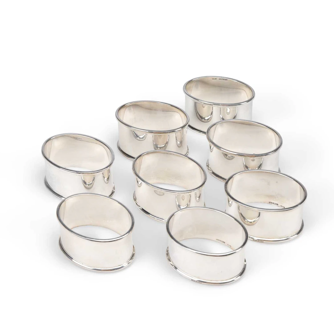 A SET OF EIGHT CHARLES III NAPKIN RINGS