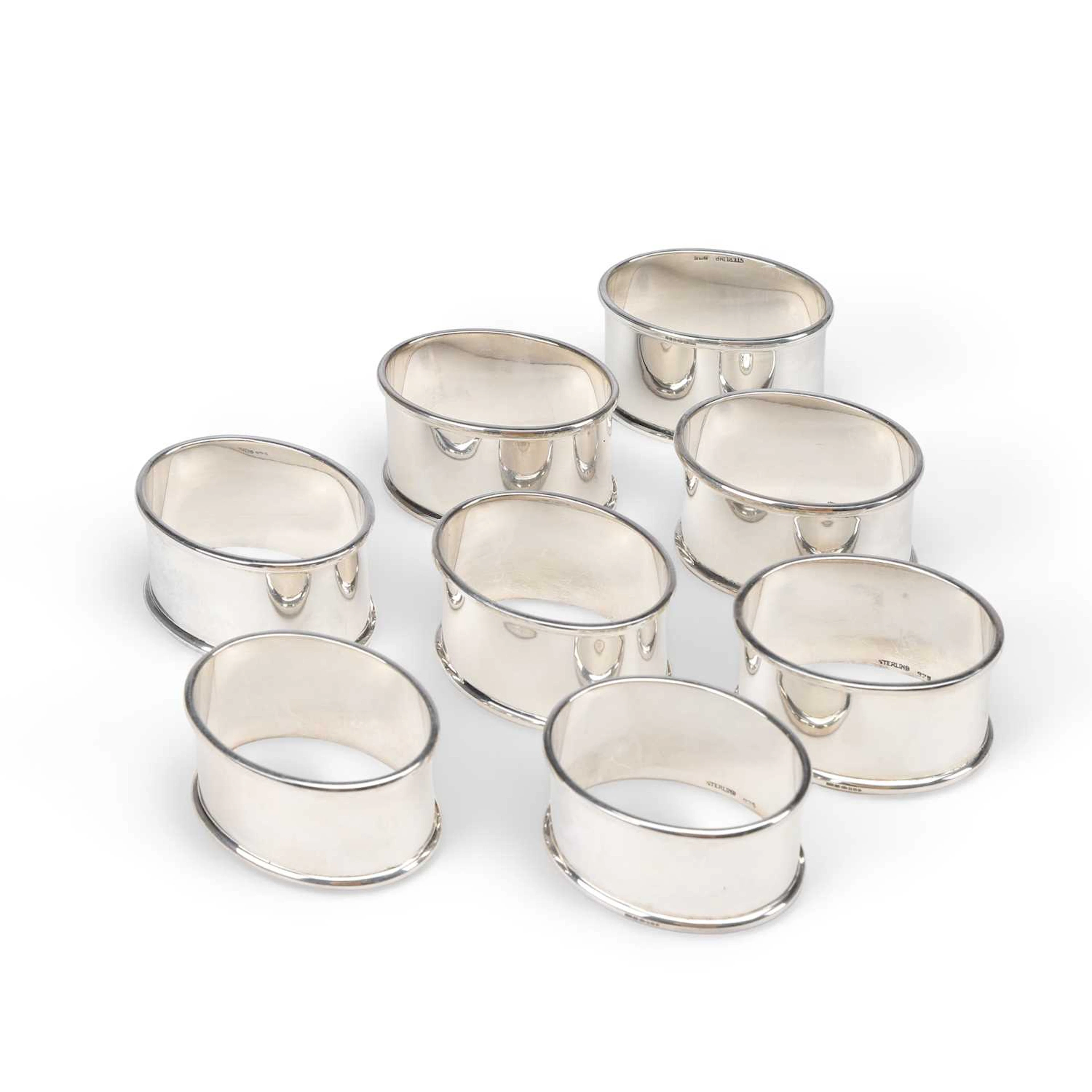 A SET OF EIGHT CHARLES III NAPKIN RINGS