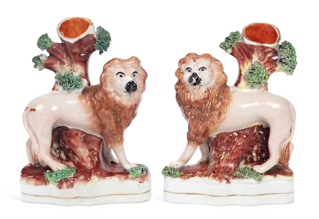 A PAIR OF STAFFORDSHIRE LION SPILL VASES 19TH CENTURY