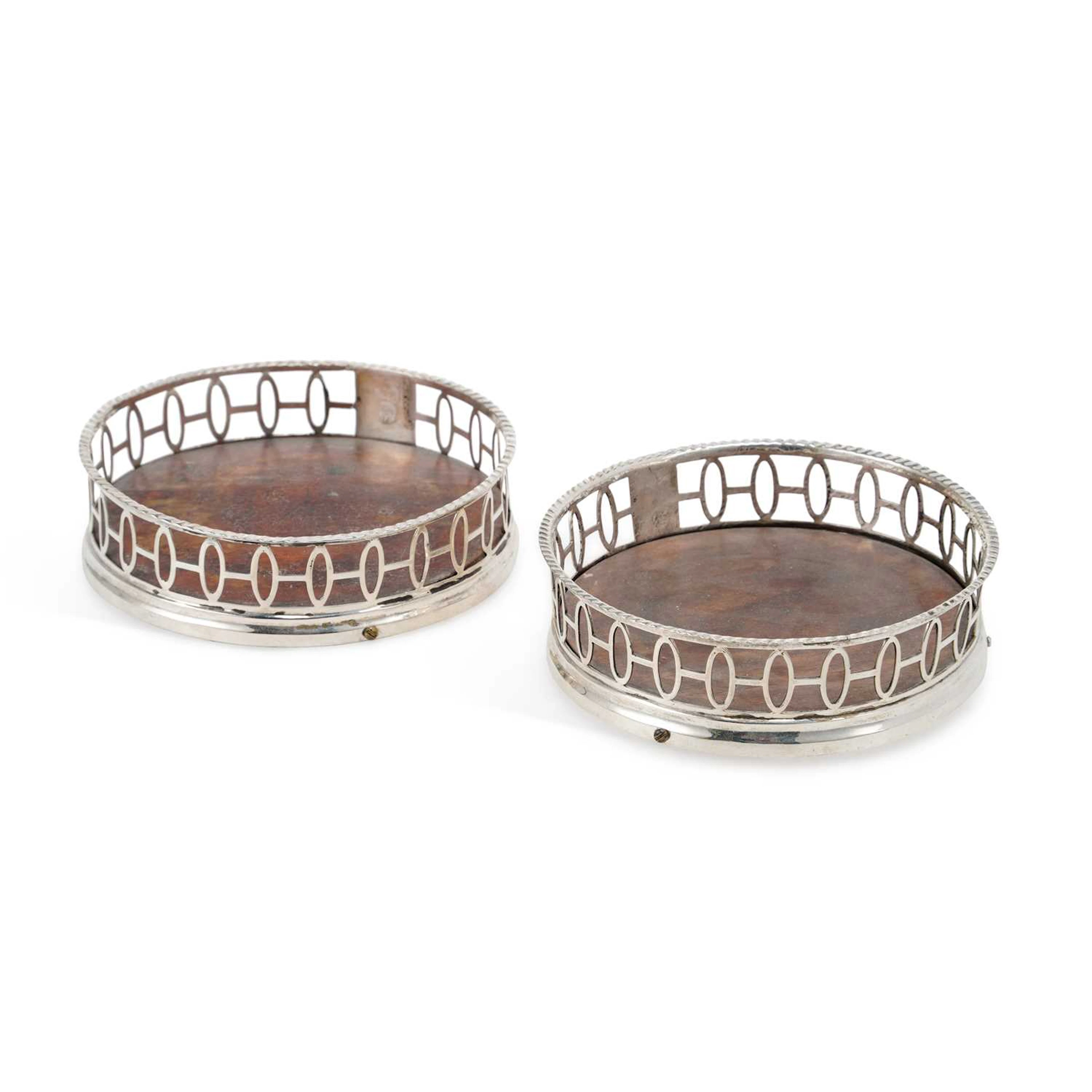 A PAIR OF GERMAN/ DUTCH SILVER WINE BOTTLE COASTERS