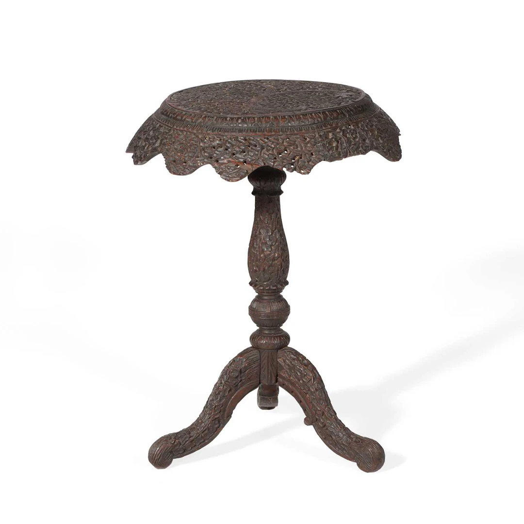 AN INDIAN CARVED HARDWOOD OCCASIONAL TABLE