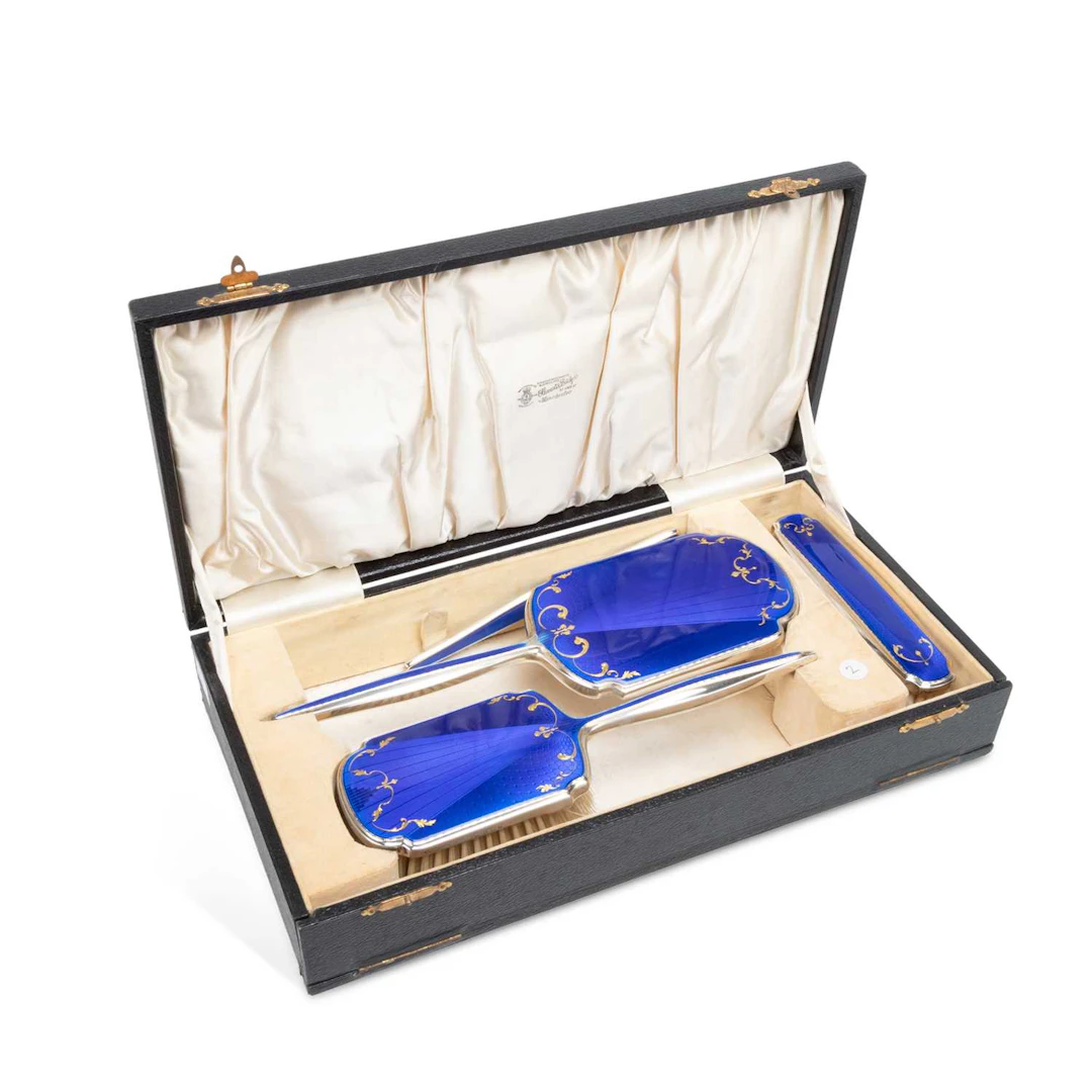 AN ART DECO SILVER AND ENAMEL MATCHED DRESSING TABLE SET
