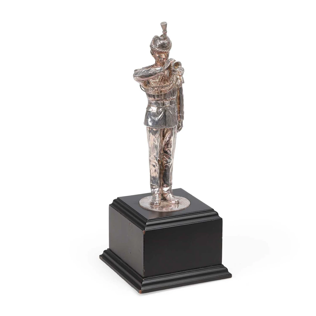 A SILVER FIGURE OF A BUGLER