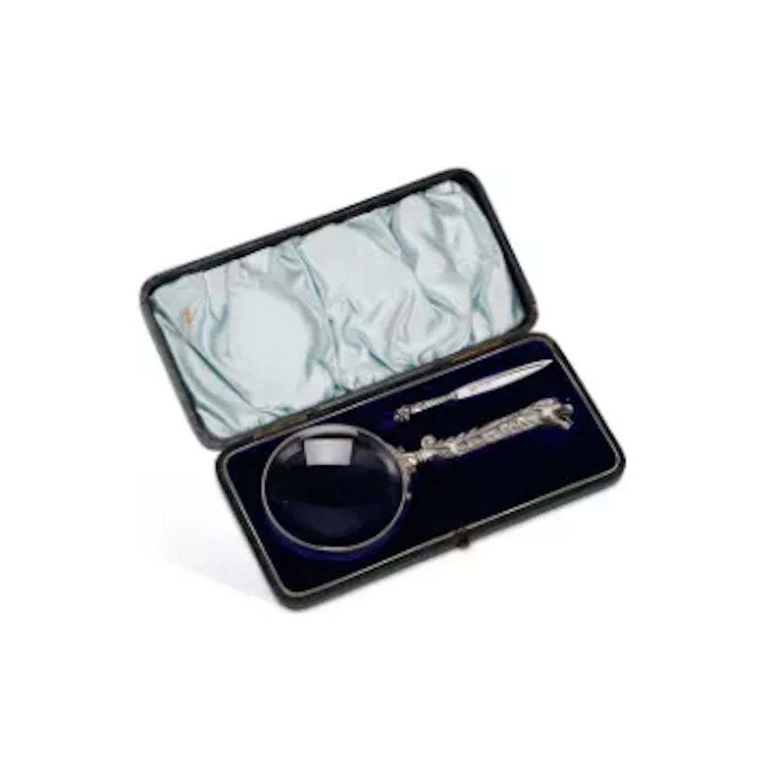 A LATE VICTORIAN SILVER-MOUNTED MAGNIFYING GLASS AND SILVER BOOKMARK SET