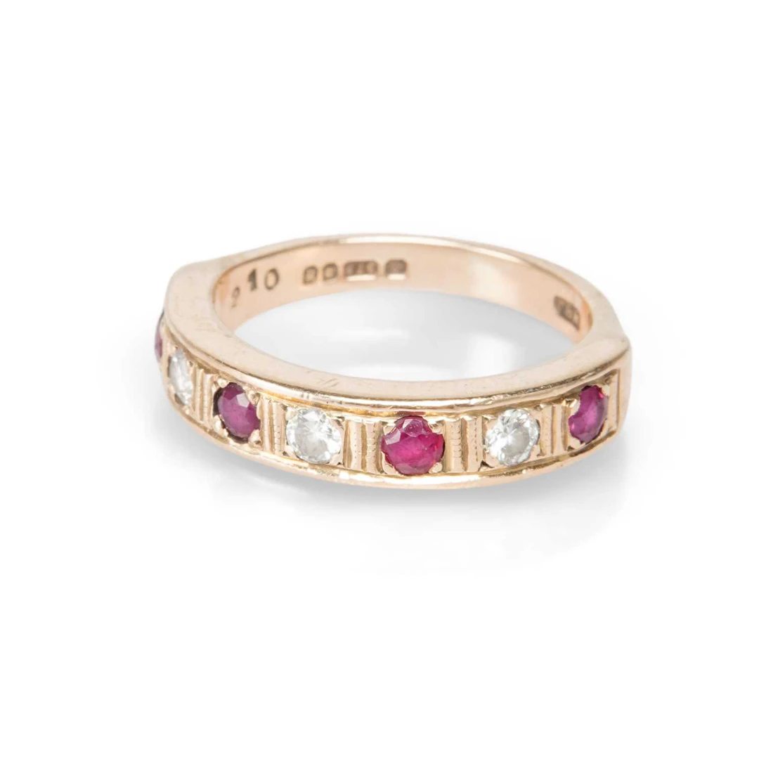 AN 18 CARAT GOLD RUBY AND DIAMOND HALF HOOP RING