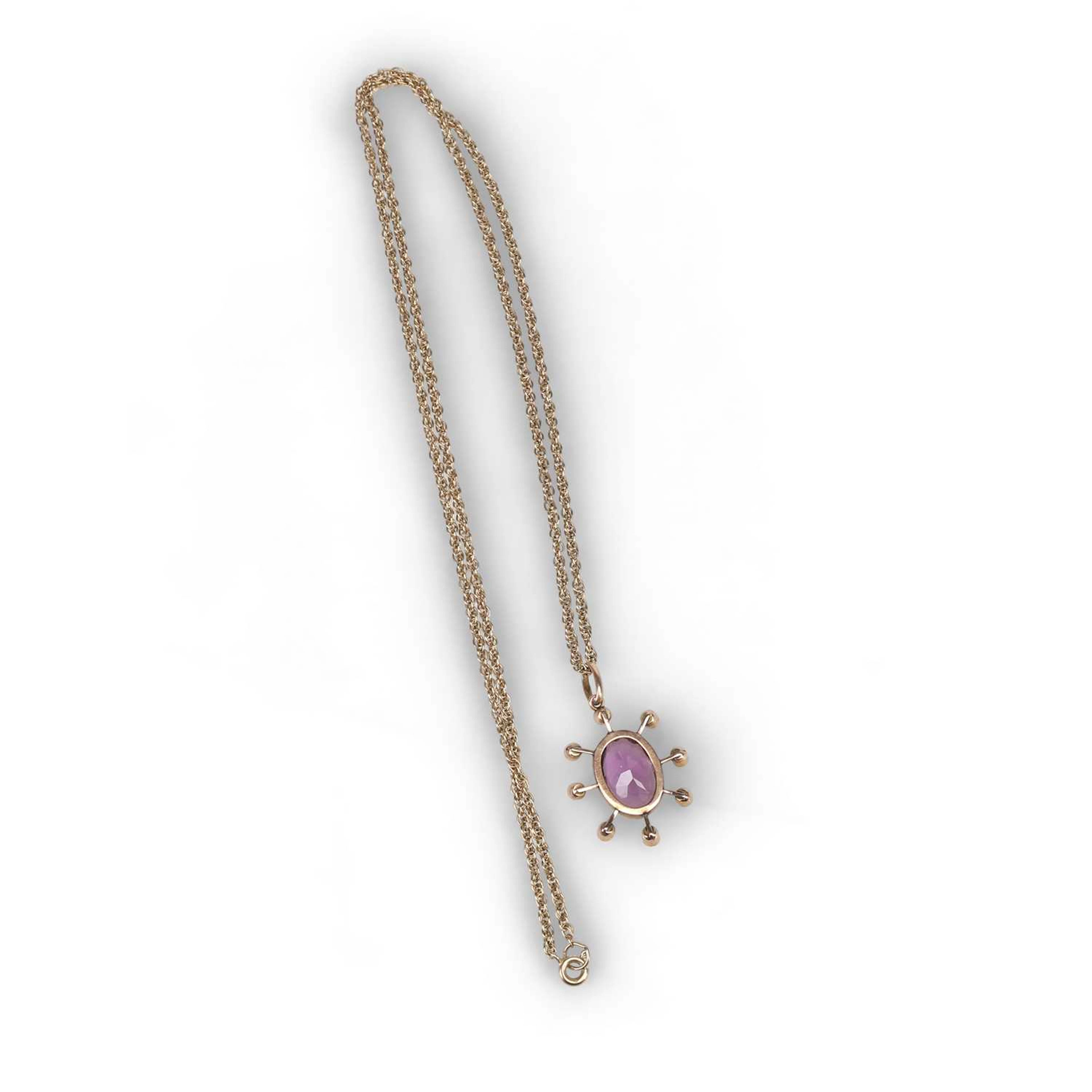 AN AMETHYST AND SEED PEARL PENDANT ON CHAIN