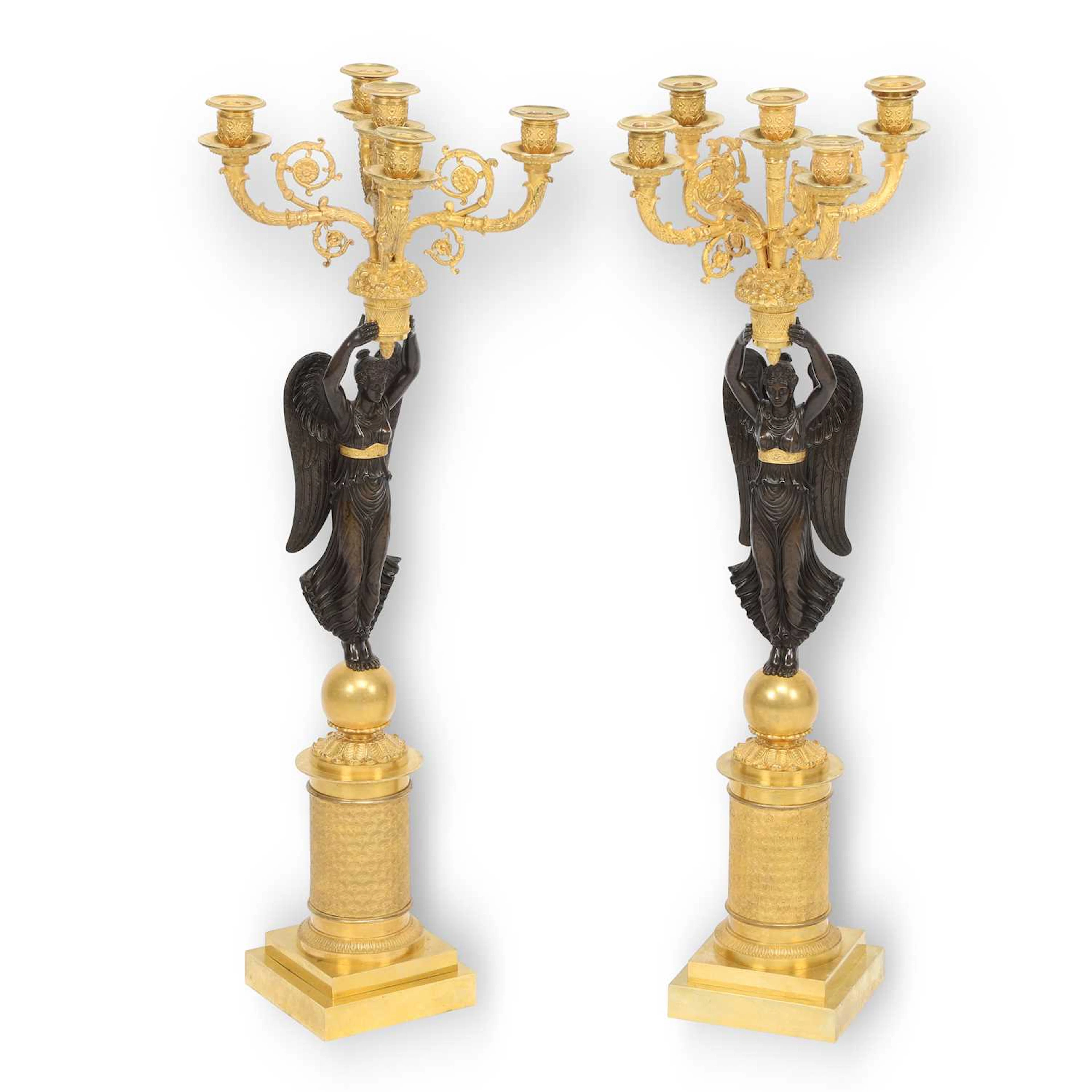 A PAIR OF FRENCH PATINATED AND GILT BRONZE SIX-LIGHT FIGURAL CANDELABRA