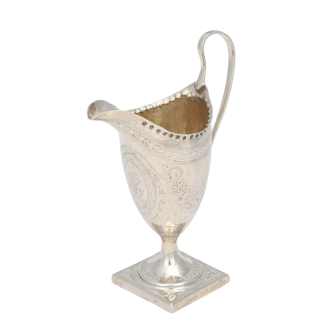 A GEORGE III SILVER CREAM JUG