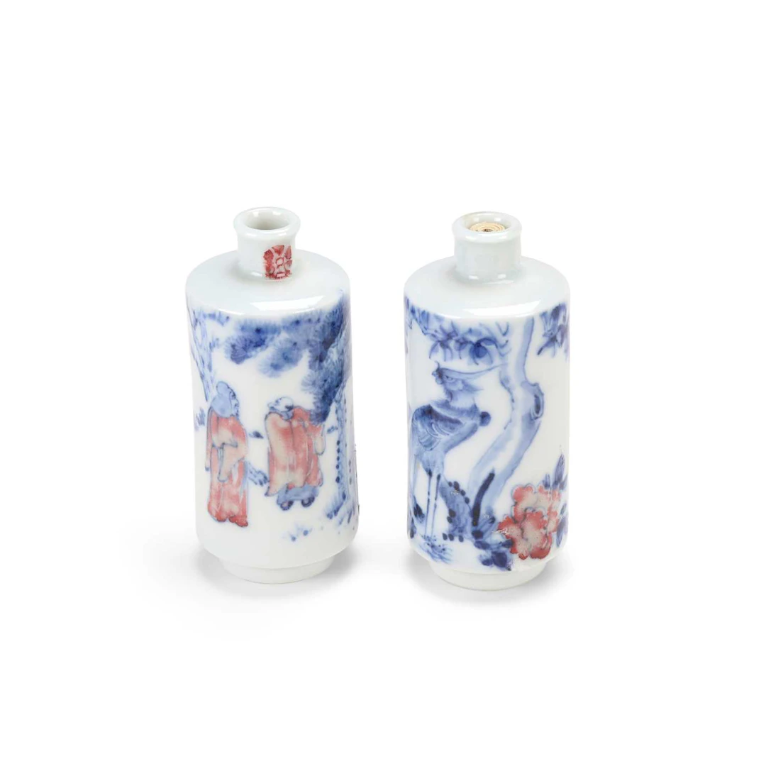 A PAIR OF CHINESE UNDERGLAZE BLUE AND COPPER RED SNUFF BOTTLES