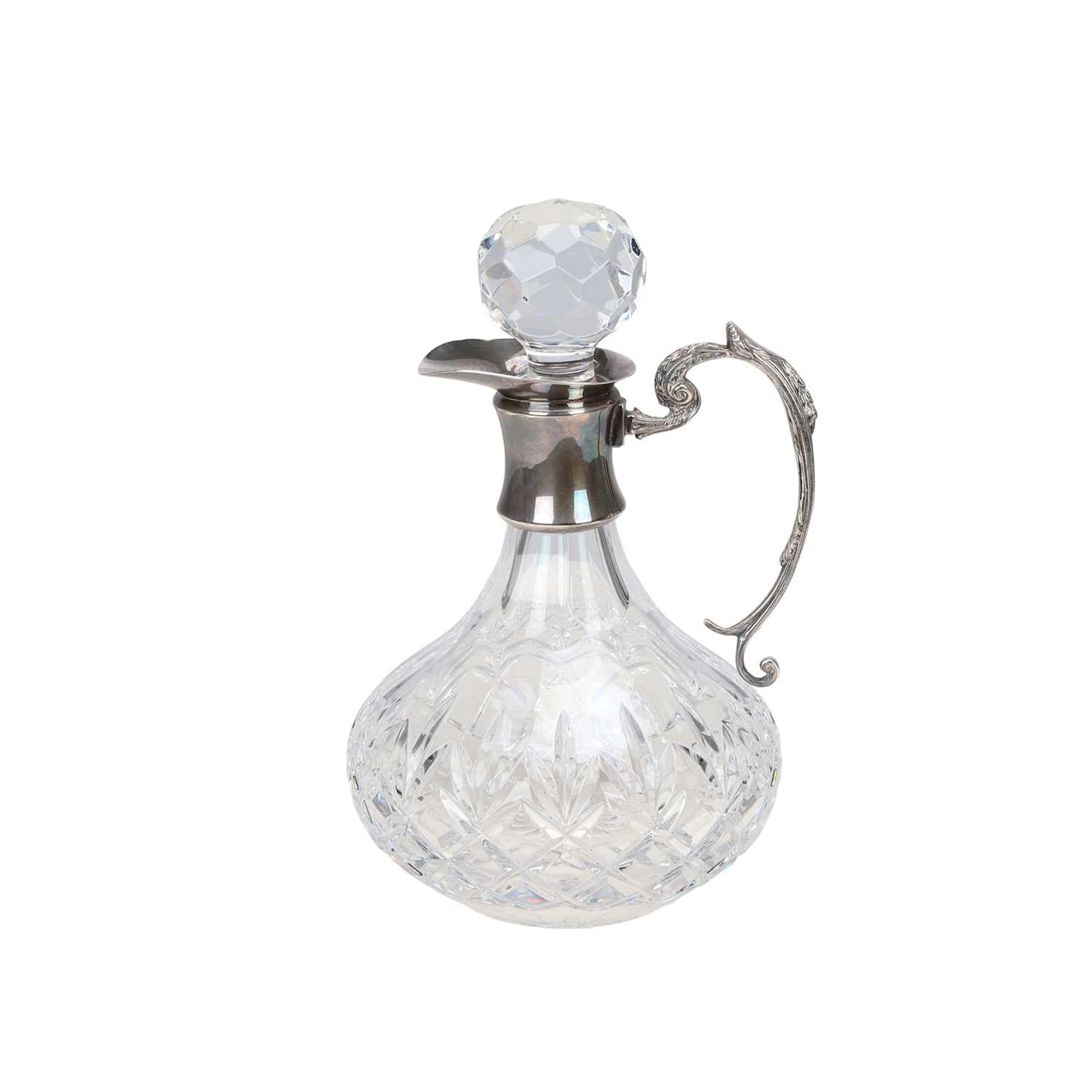 A SILVER-MOUNTED CUT-GLASS CLARET JUG