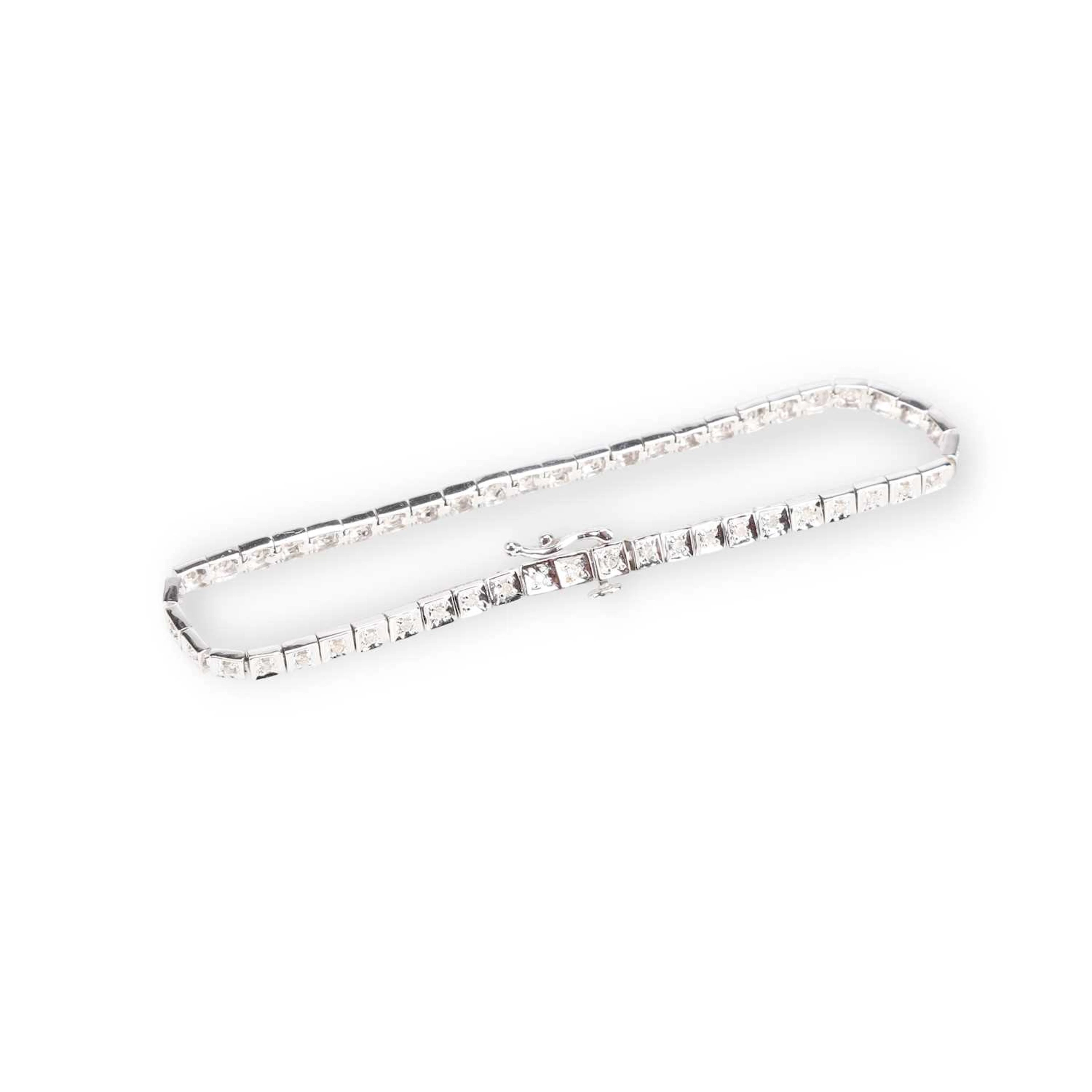 A 9 CARAT WHITE GOLD DIAMOND LINE BRACELET
